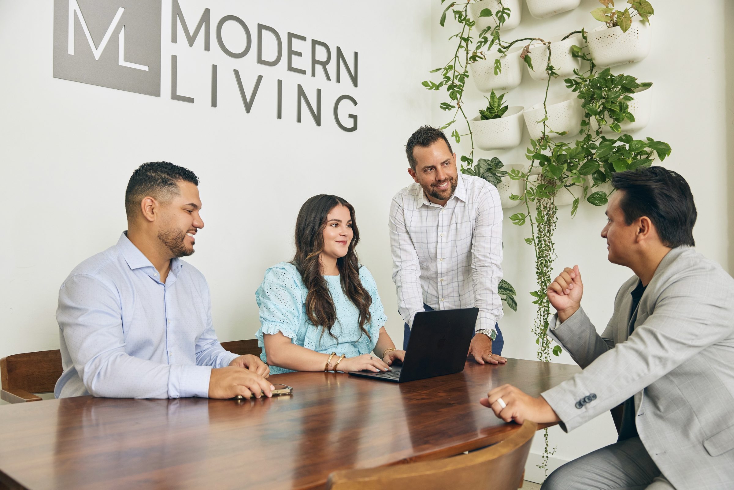 Modern Living Group listing team strategizing around the table at the West Palm Beach office